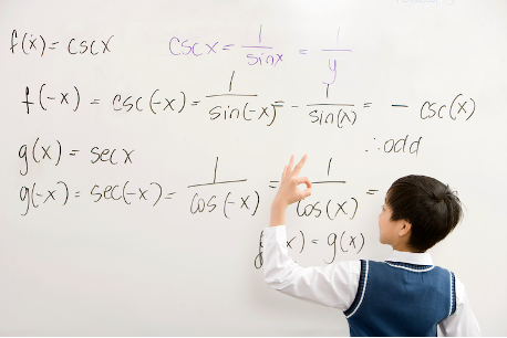 student writing math formula on whiteboard